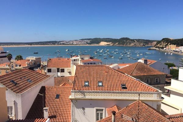 Red clay rooftops and view of Sao Martinho do Porto Bay