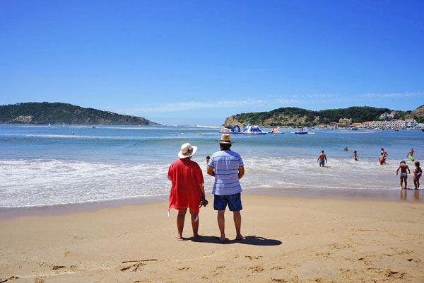 Couple looking at Sao Martinho do Porto Bay